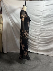 Detail of ruffle trim and bow accent on women's bodycon brushstroke print maxi dress