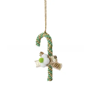 Detailed view of candy cane Christmas ornament with green-gold rope and velvet balls