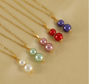 Detailed view of colorful 18k gold gourd pendants with pearls on five necklaces