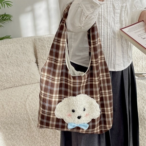 Detail of cute embroidered plush dog on brown plaid canvas tote bag for students
