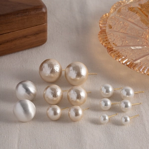Brushed metal and pearl stud earrings set with gold, silver and white spheres