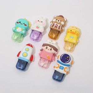 Flat lay of seven colorful retractable cartoon erasers in pastel dinosaur and animal shapes