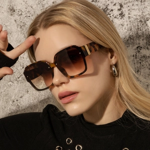 Side profile of vintage square tortoiseshell sunglasses with textured wide temple detail