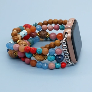 Detail of colorful multilayer beaded watch band with wooden accents and metal connector