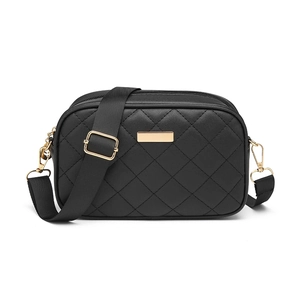 Classic black quilted crossbody camera bag with wide nylon strap and gold hardware