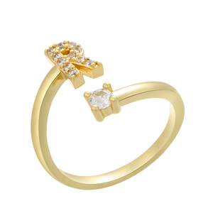 Detail of gold open ring featuring letter R with pavé zircons and a round solitaire stone