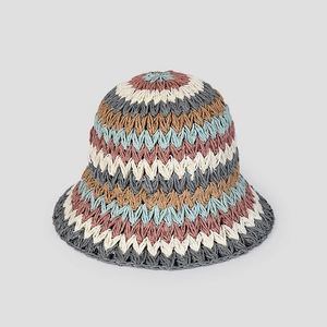 Detailed close-up of handmade crochet patterns on a colorful striped sun hat