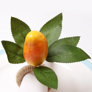 Artificial fruit napkin ring with natural jute rope loop and green leaves for table decor