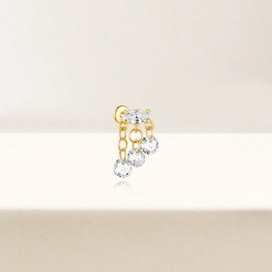 Macro shot of S925 silver gold-plated tassel stud earrings with zircon marquise stones