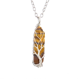 Macro detail of Tree of Life wire wrapped tiger eye hexagonal crystal pendant necklace