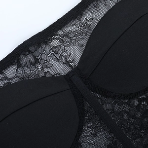 Macro shot of delicate black lace texture and fine stitching on the off-shoulder top