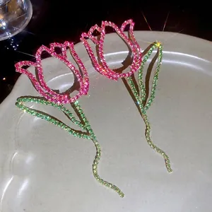 Elegant hollow tulip flower earrings featuring sparkling pink and green rhinestones
