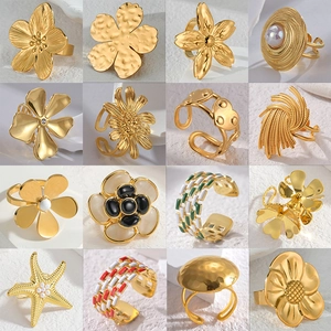 Collection of 16 trendy gold stainless steel open rings with floral and geometric designs