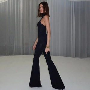 Full view of elegant black halter jumpsuit with flared trousers and professional studio lighting