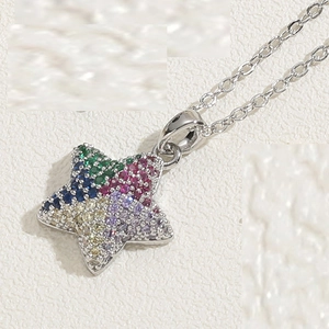 Macro detail of star pendant necklace with colorful micro-pave zircons on silver chain