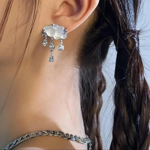Cloud and raindrop stud earrings with opal and zircon stones on a female model