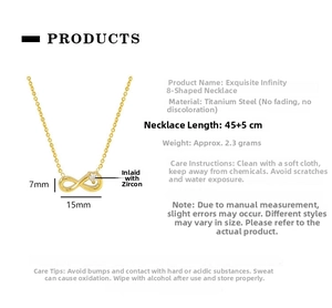 Macro shot of gold infinity symbol necklace with zircon pendant on white background
