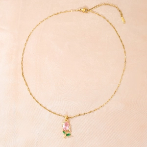 Chic golden necklace with pink zircon tulip pendant on elegant pink silk background