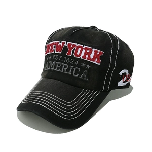 Detail of 3D New York embroidery and white contrast stitching on black cotton baseball cap