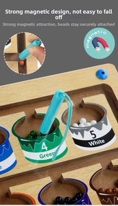 Close-up of magnetic pen picking up colorful beads for color sorting and counting