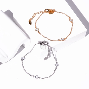 Detailed close-up of gold and silver plated butterfly bracelets with square zircon stones
