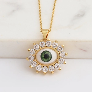 Detailed view of evil eye pendant with green zircon and sparkling pave crystals