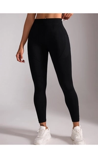 Close-up of black high-waisted yoga leggings with seamless contour stitching and elastic fit