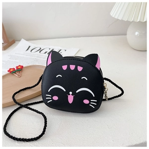 Detail view of the black cartoon cat mini PU leather crossbody bag on a white textured surface