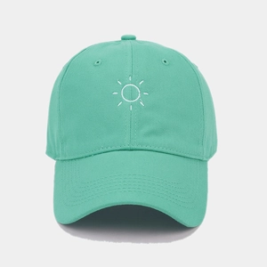 Close-up of the sun embroidery detail on the mint green cotton baseball cap
