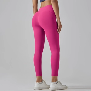 Detail view of high-waisted fuchsia yoga pants featuring V-shaped stitching for booty lift