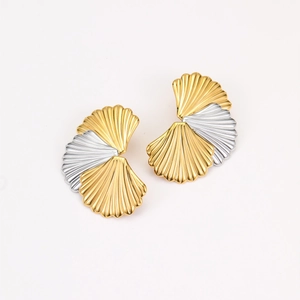 Detailed close-up of textured two-tone shell-shaped stud earrings in gold and silver