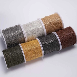 Assorted metallic DIY jewelry chains on white plastic reels in gold, silver and bronze