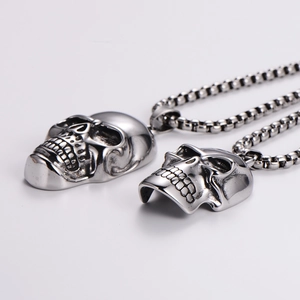 Punk style stainless steel skull pendant necklace with silver box chain on white background
