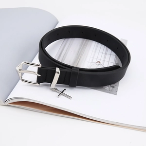 Vintage black leather belt for women featuring a silver cross charm and metal pin buckle