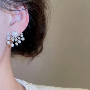 Elegant s925 silver stud earrings featuring a starburst pearl and zircon flower design