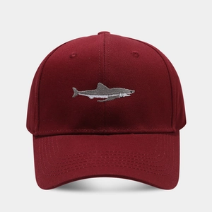 Close-up of shark embroidery on burgundy cotton twill baseball cap with detailed stitching