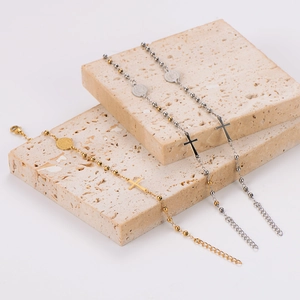 Cross and oval saint medal beaded bracelets in gold and silver on stone decor