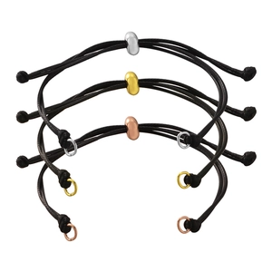 Close-up of woven cord bracelets with polished silver, gold and rose gold bean beads