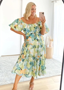 Detailed look at the off-shoulder neckline and colorful polka dot pattern of the summer dress