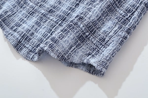 Detailed macro view of the blue and white checkered elastic smocked fabric texture