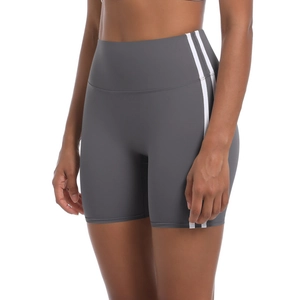 Detail of high waist dark grey yoga shorts with white side stripes and elastic fabric