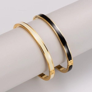 Elegant gold-plated stainless steel bangles with black and white enamel inlay