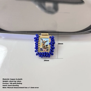 Detail of 18k gold plated religious pendant with blue beads and Michael angel engraving