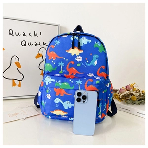 Blue dinosaur school bag size comparison shown next to an iPhone in a cozy indoor setting