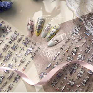 Detail of gothic Lolita nail stickers with bunny and cross patterns on acrylic tips