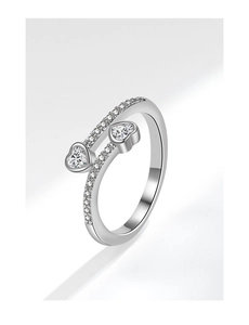Macro shot of silver heart-shaped zircon stones and pavé diamonds on the adjustable ring