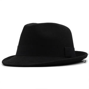 Detail of classic black wool felt fedora with a wide brim and textured ribbon band