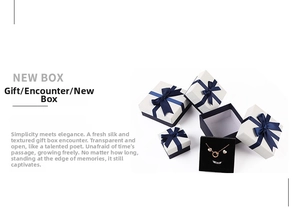 Multiple sizes of white jewelry gift boxes featuring elegant dark blue silk ribbon bows