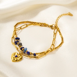 Lapis lazuli gold double layer bracelet with heart pendant on white silk background