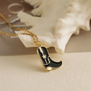 Fashionable gold plated necklace with black enamel cowboy boot pendant and star detail